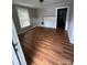 Simple living room with laminate flooring and natural light from window at 926 Cantwell St, Charlotte, NC 28208