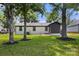 Backyard view of painted brick home with mature trees and fresh landscaping at 1067 Winchester Dr, Rock Hill, SC 29730