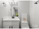 Bright bathroom with single sink vanity and stylish decor next to toilet at 1067 Winchester Dr, Rock Hill, SC 29730