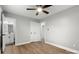 Bedroom with ceiling fan and 2 closets, open to an en suite bathroom, featuring modern wood-look flooring at 1067 Winchester Dr, Rock Hill, SC 29730