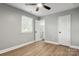 Bedroom with ceiling fan and window and featuring modern, light-colored, wood-look flooring at 1067 Winchester Dr, Rock Hill, SC 29730