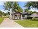 Attractive home with fresh landscaping, painted brick, chimney, and a long concrete driveway at 1067 Winchester Dr, Rock Hill, SC 29730