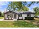 Charming single-story home with a painted brick facade, dark shutters, and a manicured front lawn at 1067 Winchester Dr, Rock Hill, SC 29730