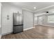 Open-concept kitchen featuring stainless steel refrigerator, white cabinets, and hardwood floors at 1067 Winchester Dr, Rock Hill, SC 29730