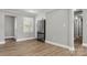 Modern kitchen area with white cabinets, stainless steel refrigerator, and hardwood floors at 1067 Winchester Dr, Rock Hill, SC 29730