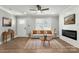 Modern living room featuring hardwood floors, a ceiling fan, and electric fireplace at 1067 Winchester Dr, Rock Hill, SC 29730