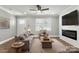Bright living room boasts hardwood floors, ceiling fan, and modern fireplace and is freshly painted at 1067 Winchester Dr, Rock Hill, SC 29730