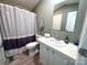 Well-lit bathroom with white vanity, modern fixtures, and a shower with a stylish striped curtain at 108 Sailors Ct # 108 B, Mount Gilead, NC 27306