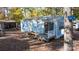 Charming light blue home with a small deck, set among mature trees and foliage at 108 Sailors Ct # 108 B, Mount Gilead, NC 27306