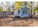 Light blue house with small porch and deck, nestled in a setting surrounded by trees at 108 Sailors Ct # 108 B, Mount Gilead, NC 27306