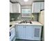 Close-up on kitchen featuring stainless steel sink, white cabinets, and a window that provides natural light at 108 Sailors Ct # 108 B, Mount Gilead, NC 27306