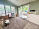Cozy living space with neutral carpet, vaulted ceilings, and access to a porch at 108 Sailors Ct # 108 B, Mount Gilead, NC 27306