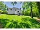 Expansive backyard with a patio area, lush green lawn, and privacy fencing at 1134 Blueberry Ln, Charlotte, NC 28226