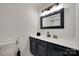 Half bathroom featuring granite countertops, black cabinets, and a white toilet at 1134 Blueberry Ln, Charlotte, NC 28226
