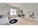 Bright bedroom features hardwood floors, large window, white walls, and closet at 1134 Blueberry Ln, Charlotte, NC 28226