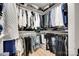 Walk-in closet featuring built in shelves and a variety of clothing at 1134 Blueberry Ln, Charlotte, NC 28226