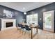 Dining room with fireplace, large windows, hardwood floors, and stylish decor at 1134 Blueberry Ln, Charlotte, NC 28226