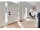 Inviting entryway with hardwood floors, white door, and modern decor at 1134 Blueberry Ln, Charlotte, NC 28226