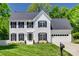 Beautiful two-story home with a well-manicured lawn, black shutters, and a two-car garage at 1134 Blueberry Ln, Charlotte, NC 28226