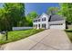 Charming two-story home featuring a manicured lawn, picket fence, and a spacious driveway at 1134 Blueberry Ln, Charlotte, NC 28226