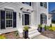 Elegant front entrance with black door, white trim, and manicured landscaping at 1134 Blueberry Ln, Charlotte, NC 28226