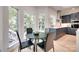 Cozy kitchen nook with large windows, hardwood floors, and a modern table set at 1134 Blueberry Ln, Charlotte, NC 28226