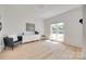 Bright living room featuring hardwood floors, large windows, and modern decor at 1134 Blueberry Ln, Charlotte, NC 28226