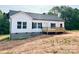 Newly built home with white siding, black shutters, and a wood deck at 118 Brett Will Ct, Taylorsville, NC 28681