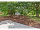 Spacious backyard featuring a small storage shed and mature trees for privacy at 1192 Carolyn Dr # 9, Albemarle, NC 28001