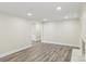 A finished basement with wood-look flooring, white trim, neutral paint, and recessed lighting at 1192 Carolyn Dr # 9, Albemarle, NC 28001