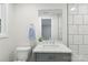The bathroom features a vanity with gray cabinets, marble countertop, modern fixtures, and white marble tile backsplash at 1192 Carolyn Dr # 9, Albemarle, NC 28001