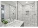 This bathroom showcases white marble tiling, a modern shower with black accent tiles, and modern fixtures at 1192 Carolyn Dr # 9, Albemarle, NC 28001