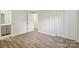 Bright bedroom featuring neutral walls, hardwood flooring, and a closet with sliding doors at 1192 Carolyn Dr # 9, Albemarle, NC 28001
