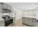 A modern kitchen featuring gray cabinetry, stainless steel appliances, and bright, recessed lighting at 1192 Carolyn Dr # 9, Albemarle, NC 28001