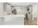 A well-lit kitchen with gray cabinets, a white countertop island, and stainless steel appliances at 1192 Carolyn Dr # 9, Albemarle, NC 28001