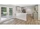A well-lit kitchen with gray cabinets, a white countertop island, and stainless steel appliances at 1192 Carolyn Dr # 9, Albemarle, NC 28001