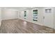 Light-filled living room with stylish wood floors and a classic chandelier at 1192 Carolyn Dr # 9, Albemarle, NC 28001