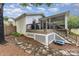 Beautiful backyard with a deck and screened porch, leading to a well-maintained lawn and surrounding landscape at 127 Leonidas St, Fort Mill, SC 29715