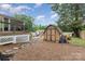 Spacious backyard featuring a large shed, fire pit, and manicured landscaping, ideal for outdoor enjoyment at 127 Leonidas St, Fort Mill, SC 29715