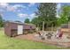 Large backyard features a storage shed, a fire pit with chairs, and a spacious lawn with mature trees at 127 Leonidas St, Fort Mill, SC 29715