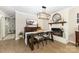 Dining room with a brick fireplace, modern chandelier, and stylish decor at 127 Leonidas St, Fort Mill, SC 29715