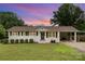 Charming single-story home with a well-maintained front yard and a carport, set against a vibrant sky at 127 Leonidas St, Fort Mill, SC 29715