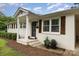 Close up of charming white brick home with wooden shutters and freshly landscaped front porch at 127 Leonidas St, Fort Mill, SC 29715