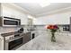 Well-lit kitchen features white cabinets, stainless steel appliances, and granite countertops at 127 Leonidas St, Fort Mill, SC 29715