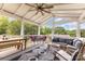 Inviting screened patio with a ceiling fan, dining table, and cozy seating area, perfect for outdoor relaxation at 127 Leonidas St, Fort Mill, SC 29715