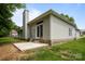 Home showcasing backyard with concrete patio, lush grass, and exterior chimney at 1321 Land Grant Rd, Charlotte, NC 28217