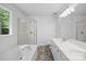 Bright bathroom featuring a tub, shower, and double vanity at 1321 Land Grant Rd, Charlotte, NC 28217
