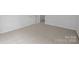 Neutral carpeted bedroom featuring double closets and ample natural light at 1321 Land Grant Rd, Charlotte, NC 28217