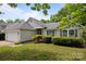 Charming home with manicured lawn and mature landscaping at 1321 Land Grant Rd, Charlotte, NC 28217