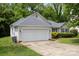 Home featuring an attached two-car garage and a well-kept lawn at 1321 Land Grant Rd, Charlotte, NC 28217